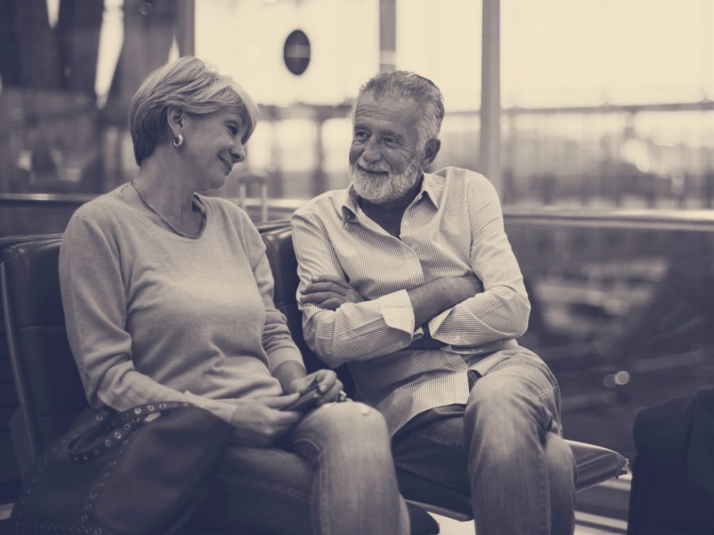 Senior couple traveling airport scene